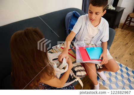 Two kids organizing school supplies 122882967