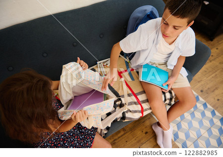 Children Organizing Books On Couch Children Organizing Books On Couch 122882985