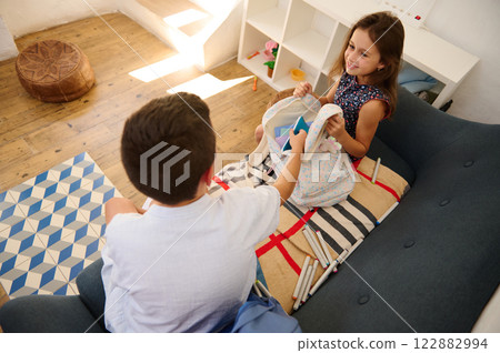 Children organizing school stationery 122882994