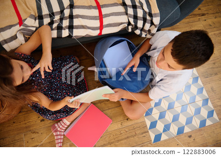 Children working together on homework 122883006