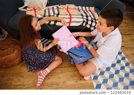 Children Organizing School Supplies Together 122883019