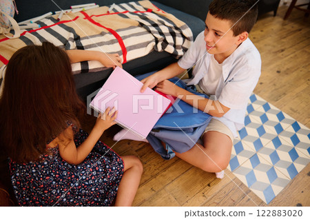 Children engaging in homework together Children engaging in homework together 122883020