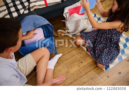 Children organizing school supplies together Children organizing school supplies together 122883038