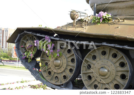 flowers near the tank at the memorial to those killed in the war 122883347