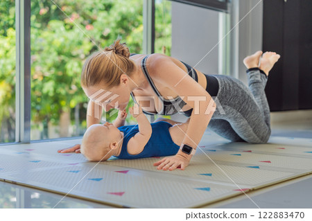 A mother works out with her 3-month-old baby, incorporating fitness and bonding into a joyful routine. A heartwarming moment of parenting, love, and a healthy lifestyle. Family, care, and active A mother works out with her 3-month-old baby, incorporating fitness and bonding into a joyful routine. A heartwarming moment of parenting, love, and a healthy lifestyle. Family, care, and active 122883470
