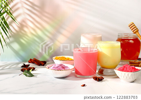 An assortment of colorful matcha lattes, Japanese tea, golden turmeric, lavender blue and pink moon milk. The trendy healthy drink promotes weight loss, a relaxing drink before bed and has An assortment of colorful matcha lattes, Japanese tea, golden turmeric, lavender blue and pink moon milk. The trendy healthy drink promotes weight loss, a relaxing drink before bed and has 122883703