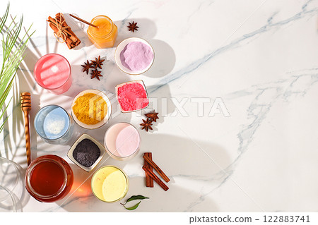 An assortment of colorful matcha lattes, Japanese tea, golden turmeric, lavender blue and pink moon milk. The trendy healthy drink promotes weight loss, a relaxing drink before bed and has 122883741
