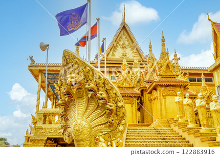 Wat Kean Kleang golden buddhist pagoda temple walls, stairs and Naga snake statue in the foreground, Phnom Penh, Cambodia 122883916