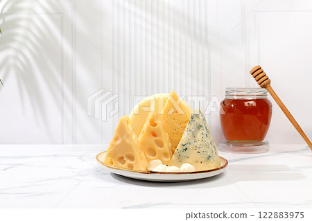 Assortment of different types of cheese, Blue cheese, Roquefort, Parmesan, Mozzarella, Maasdam with honey, Healthy and natural food selection, Advertising postcard for cafe and menu, Selective focus 122883975