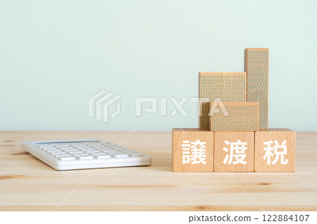 A block with the words "transfer tax" written on it, a calculator, and a model of a real estate property A block with the words "transfer tax" written on it, a calculator, and a model of a real estate property 122884107