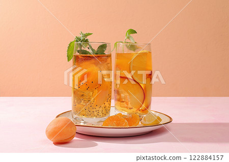Ice cold homemade lemonade or cocktail with mint, apricots, peaches, chia seeds and citrus fruits, recipe for a refreshing summer drink, detox diet and weight loss concept, menu for restaurant, Ice cold homemade lemonade or cocktail with mint, apricots, peaches, chia seeds and citrus fruits, recipe for a refreshing summer drink, detox diet and weight loss concept, menu for restaurant, 122884157