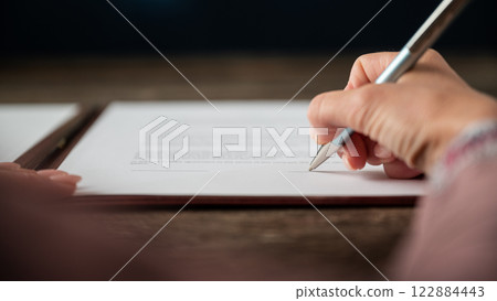 Female hand signing a document 122884443