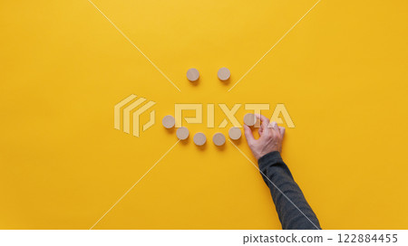 Making a smiling face of blank wooden cut circles 122884455