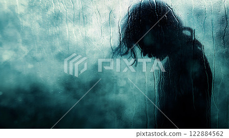 A silhouette of a person stands behind a foggy window, suggesting introspection and solitude during a rainy day A silhouette of a person stands behind a foggy window, suggesting introspection and solitude during a rainy day 122884562
