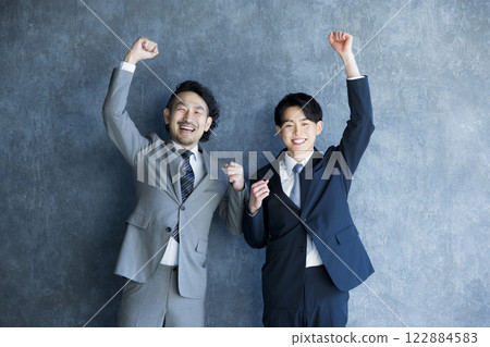 A smiling businessman doing a guts pose 122884583