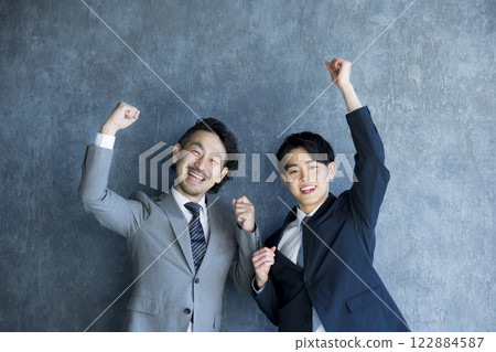 A smiling businessman doing a guts pose 122884587