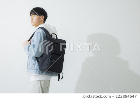 A man carrying a backpack 122884647