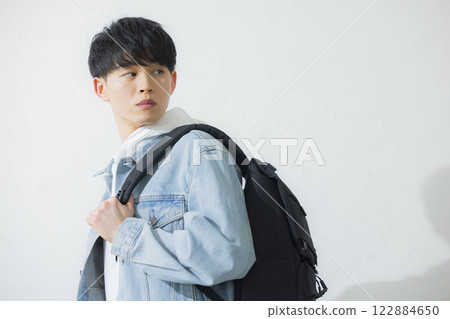 A man carrying a backpack A man carrying a backpack 122884650