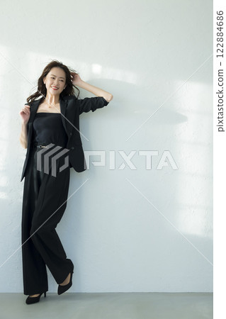 Middle-aged woman in a black suit 122884686