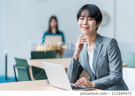 Businesswoman working in a cafe. Businesswoman working in a cafe. 122884972