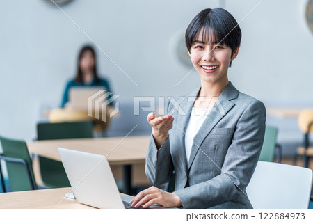 Businesswoman working in a cafe. Businesswoman working in a cafe. 122884973