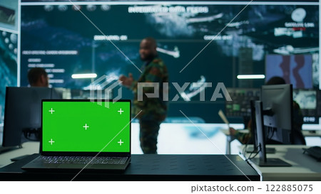 Army IT expert in control center collecting real time battlefield data, process satellite surveillance imagery for successful military defense mission. Using green screen isolated display. Camera B. Army IT expert in control center collecting real time battlefield data, process satellite surveillance imagery for successful military defense mission. Using green screen isolated display. Camera B. 122885075