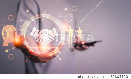 A glowing handshake icon surrounded by futuristic AI elements and digital graphics, symbolizing partnership, technology, innovation, and collaboration in a modern business context. 122885190