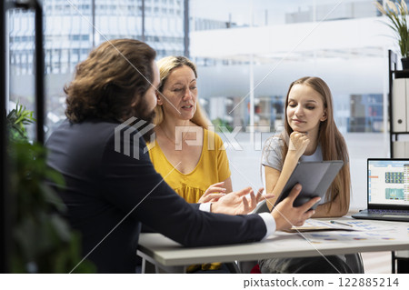 Advisor working with clients to create long term investment strategies, doing retirement planning. Consultant helps family set realistic financial goals and develop roadmap to achieve them 122885214