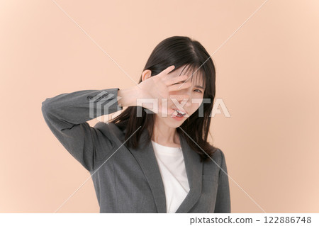 A woman in a suit posing in denial 122886748