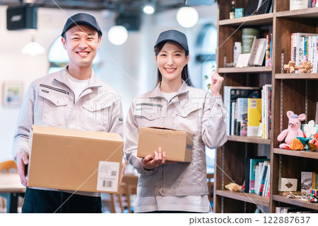 Smiling support staff sorting through belongings 122887637