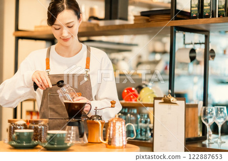 A part-time woman working at a stylish cafe 122887653