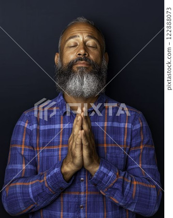 Grateful Latino Man with Clapping Hands and Blissful Expression Grateful Latino Man with Clapping Hands and Blissful Expression 122888073