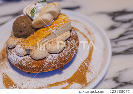 A luxurious pancake topped with cheesecake and ice cream 122888075