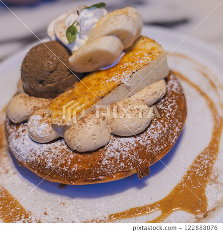A luxurious pancake topped with cheesecake and ice cream 122888076