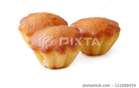 Bakery treats on a white background highlighting three golden mini cakes with a smooth texture Bakery treats on a white background highlighting three golden mini cakes with a smooth texture 122888459