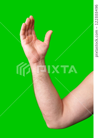 Arm raised in gesture against a bright green background 122888496