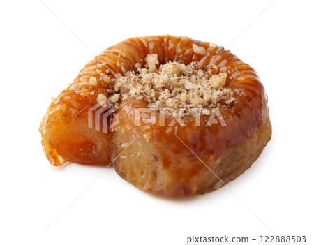 Traditional dessert with nuts, honey, and flaky pastry served on a white background 122888503