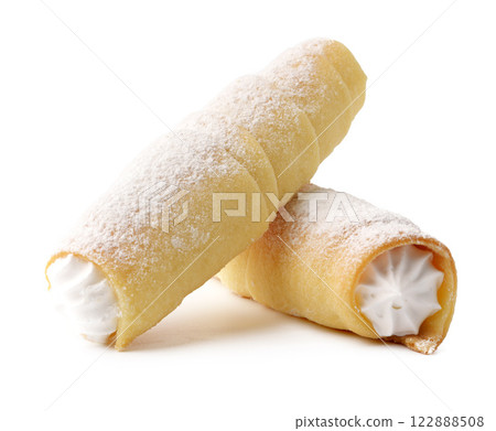 Delicious sweet cannoli filled with creamy ricotta and dusted with powdered sugar during a dessert presentation Delicious sweet cannoli filled with creamy ricotta and dusted with powdered sugar during a dessert presentation 122888508