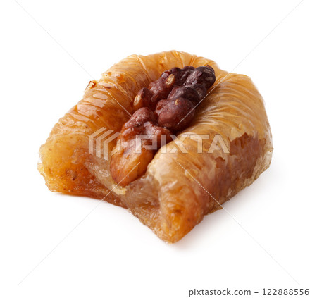 Traditional dessert featuring nut filling served on a plate during a festive gathering Traditional dessert featuring nut filling served on a plate during a festive gathering 122888556