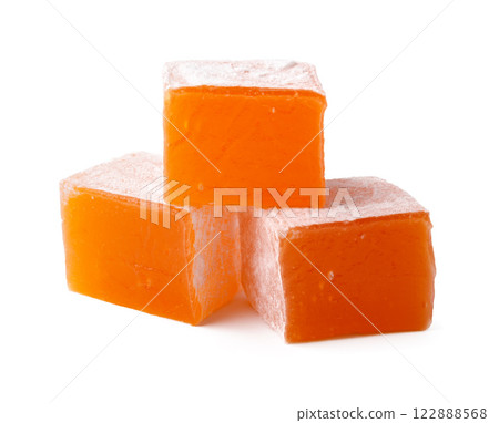 Delicious orange jelly squares stacked on a white background showcasing their vibrant color and smooth texture for dessert lovers Delicious orange jelly squares stacked on a white background showcasing their vibrant color and smooth texture for dessert lovers 122888568