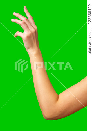 Hand gesture against a bright green background conveys a sense of reaching or interaction 122888569