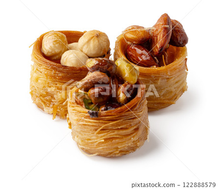 Delicious dessert featuring a variety of nuts wrapped in sweet pastry, perfect for festive occasions or indulgent treats 122888579