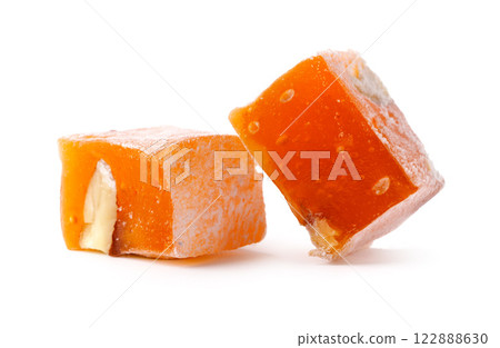 Delicious orange fruit confection with nuts offers a burst of flavor and sweetness for dessert lovers 122888630