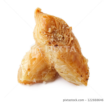 Sweet pastry displayed on a white background highlighting its intricate layers and golden-brown color Sweet pastry displayed on a white background highlighting its intricate layers and golden-brown color 122888646
