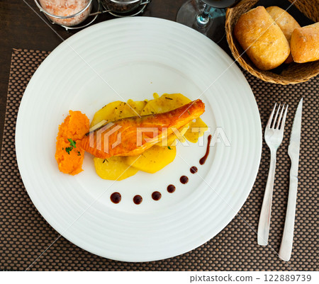 Salmon with potato and sweet potato puree 122889739