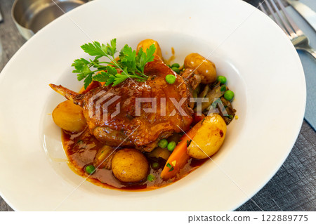 Braised duck leg with vegetables 122889775