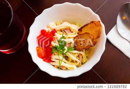 Salad of cabbage, eggs, sausages and mayonnaise with toasted baguette 122889782