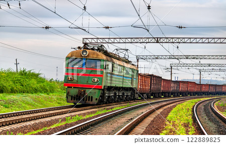 Old electric locomotive hauling a freight train near Siversk, currently an active war zone in Russo-Ukrainian War in Donetsk region of Ukraine 122889825