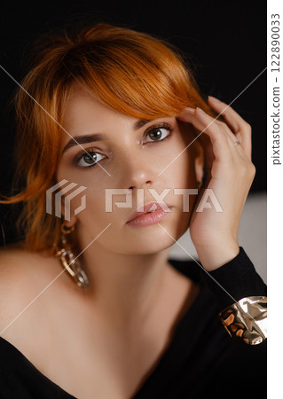 Close-up portrait of a young woman with bright red hair 122890033
