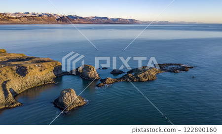 Aerial landscape of the cliff and ocean view with sunrise scene on Arnarstapi, Iceland. Taken by drone. Nature, travel, winter background, or wallpaper Aerial landscape of the cliff and ocean view with sunrise scene on Arnarstapi, Iceland. Taken by drone. Nature, travel, winter background, or wallpaper 122890160